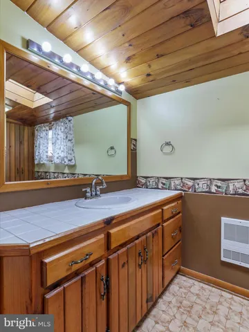 a bathroom with a sink a vanity and mirror