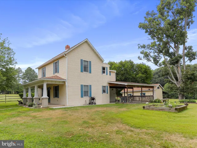 a front view of a house with a garden and porch