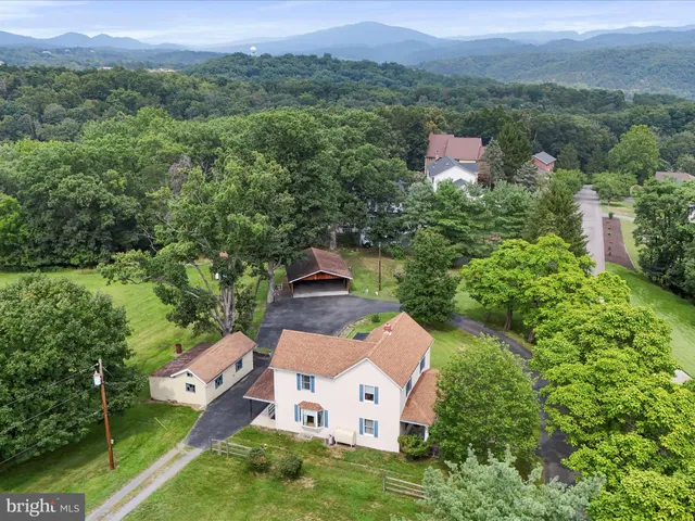 an aerial view of a house with mountain view