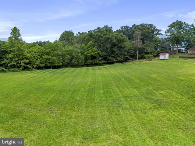 a view of a green field with clear sky