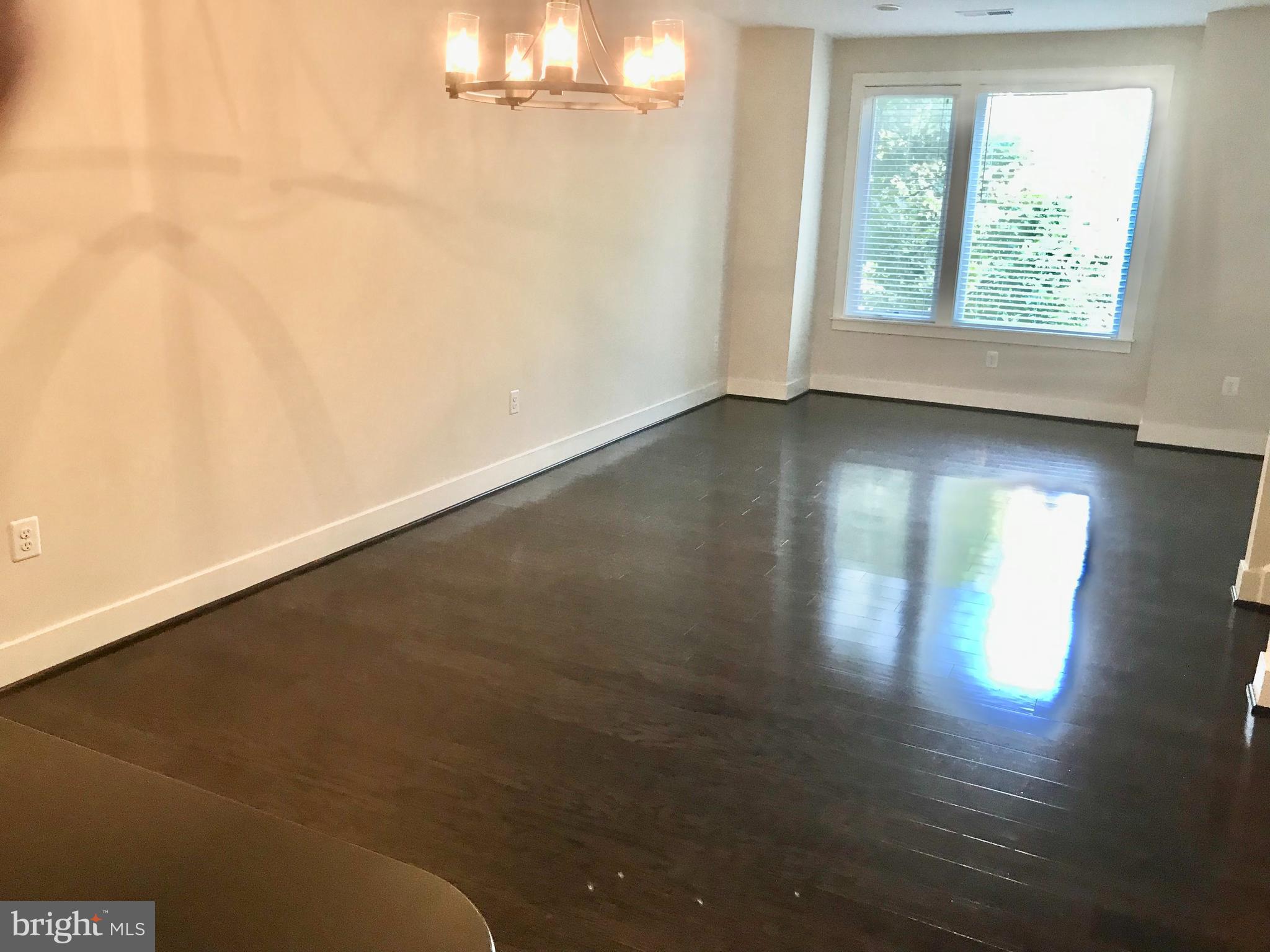 16316 Decker Place Rockville, MD 20855 - Photo 11 of 27 an empty room with wooden floor and windows