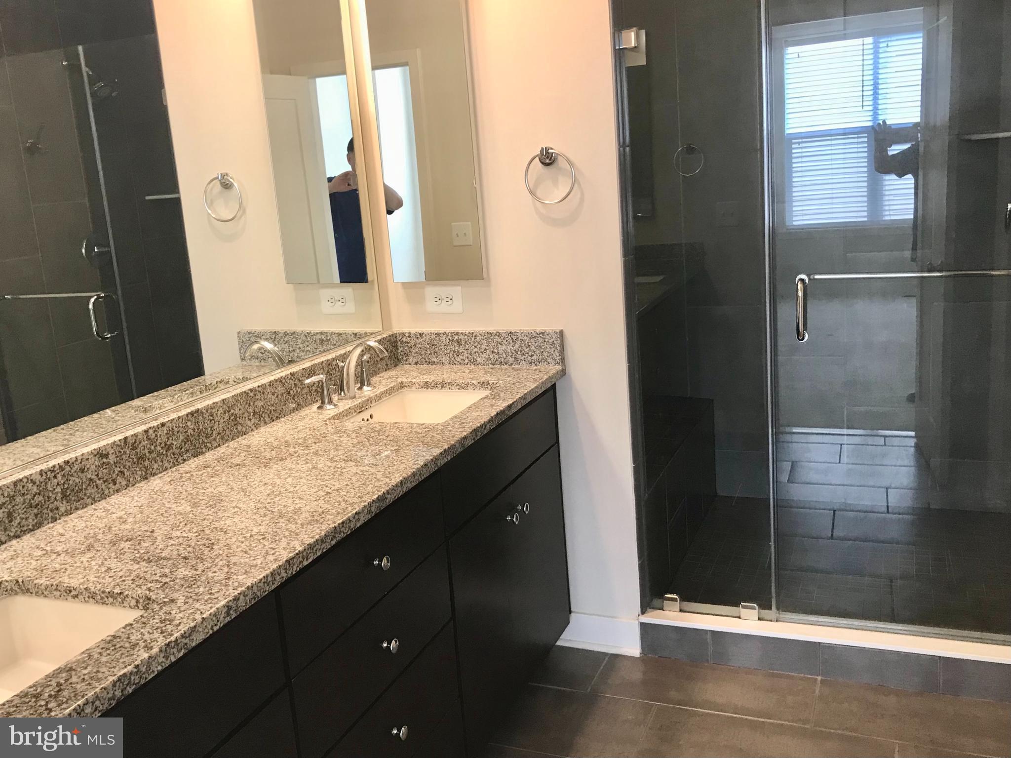 16316 Decker Place Rockville, MD 20855 - Photo 17 of 27 a bathroom with a granite countertop sink and a mirror