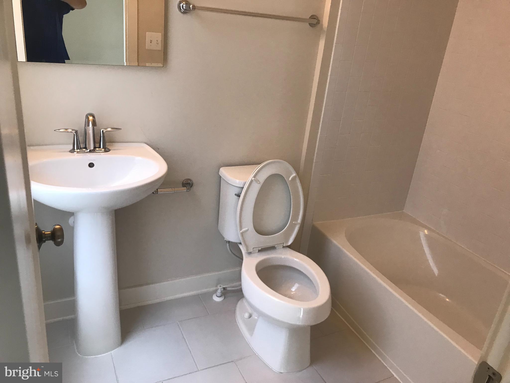 16316 Decker Place Rockville, MD 20855 - Photo 20 of 27 a bathroom with a toilet sink and mirror