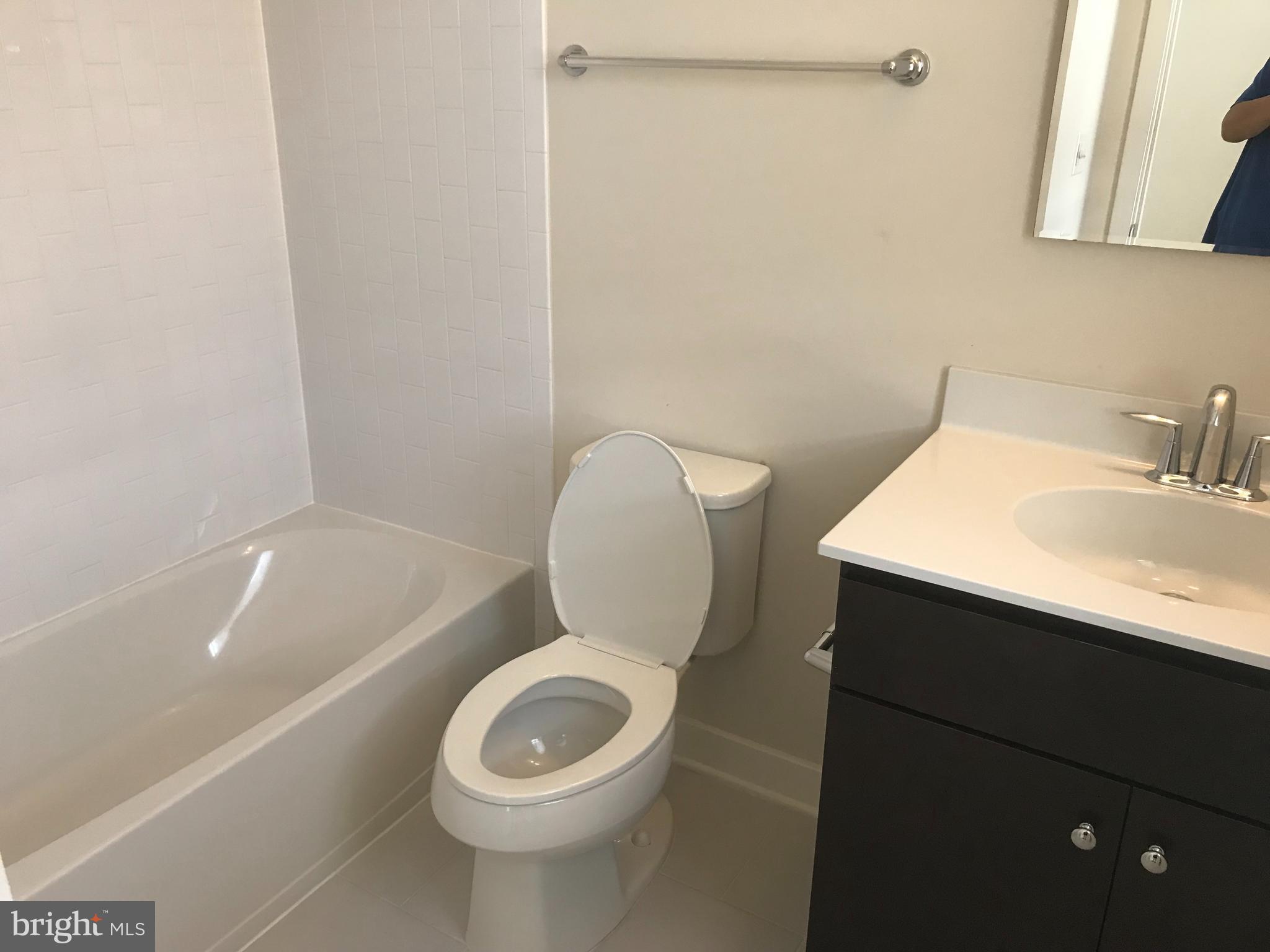 16316 Decker Place Rockville, MD 20855 - Photo 23 of 27 a bathroom with a toilet a sink and bathtub