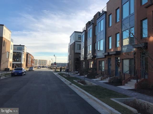 16316 Decker Place Rockville, MD 20855 - Photo 4 of 27 a city street lined with tall buildings and cars parked on street