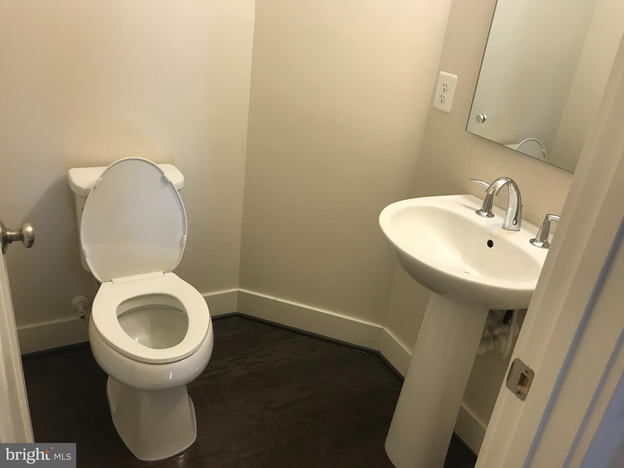 16316 Decker Place Rockville, MD 20855 - Photo 10 of 27 a bathroom with a toilet sink and a mirror