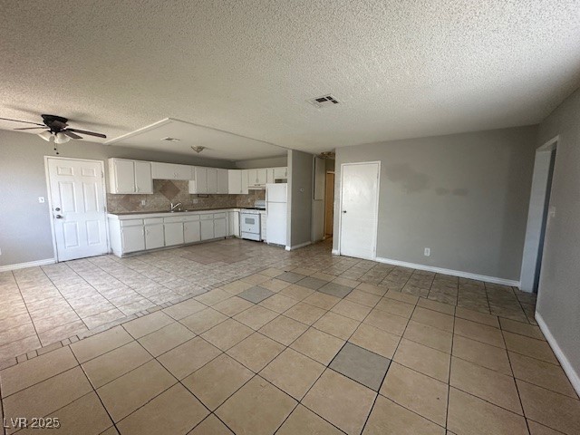 3106 Cummings Street North Las Vegas, NV 89030 - Photo 3 of 12 Unfurnished living room with light tile patterned flooring, a textured ceiling, and ceiling fan