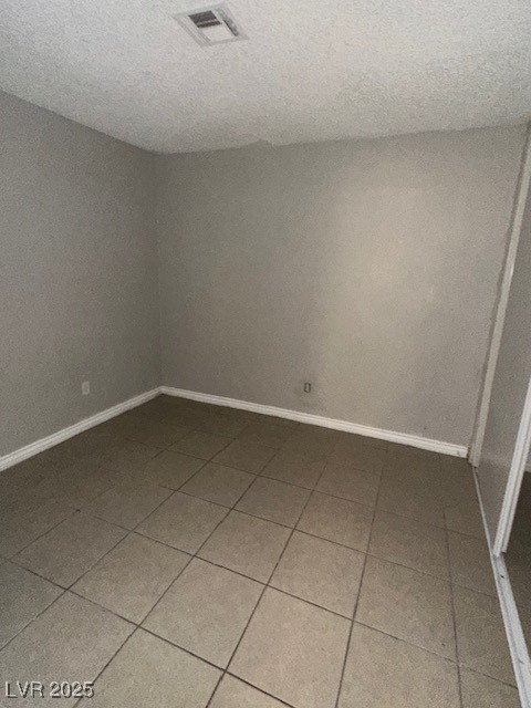 3106 Cummings Street North Las Vegas, NV 89030 - Photo 6 of 12 Empty room featuring tile patterned flooring and a textured ceiling