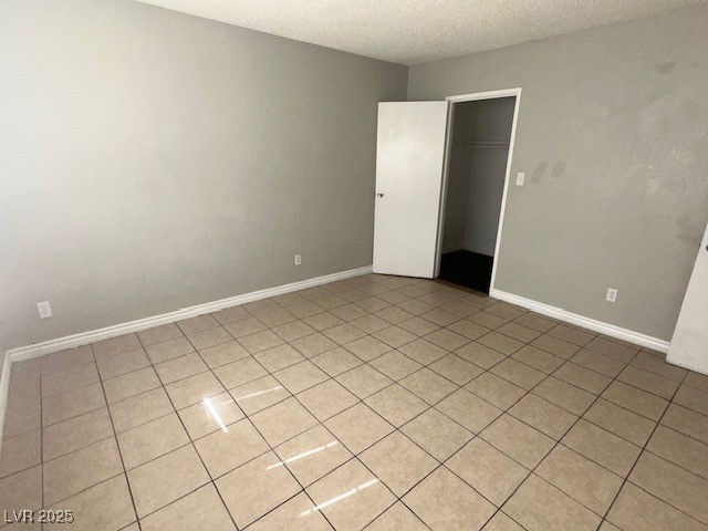 3106 Cummings Street North Las Vegas, NV 89030 - Photo 9 of 12 Unfurnished room with a textured ceiling and light tile patterned flooring
