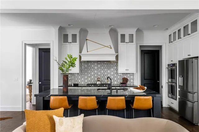a kitchen with blue cabinets and stainless steel appliances