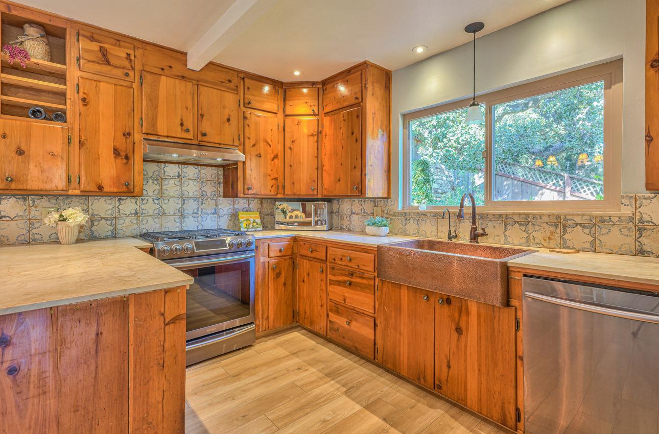 7 Paso Cresta Carmel Valley, CA 93924 - Photo 14 of 44 a kitchen with stainless steel appliances granite countertop wooden cabinets a sink and a stove