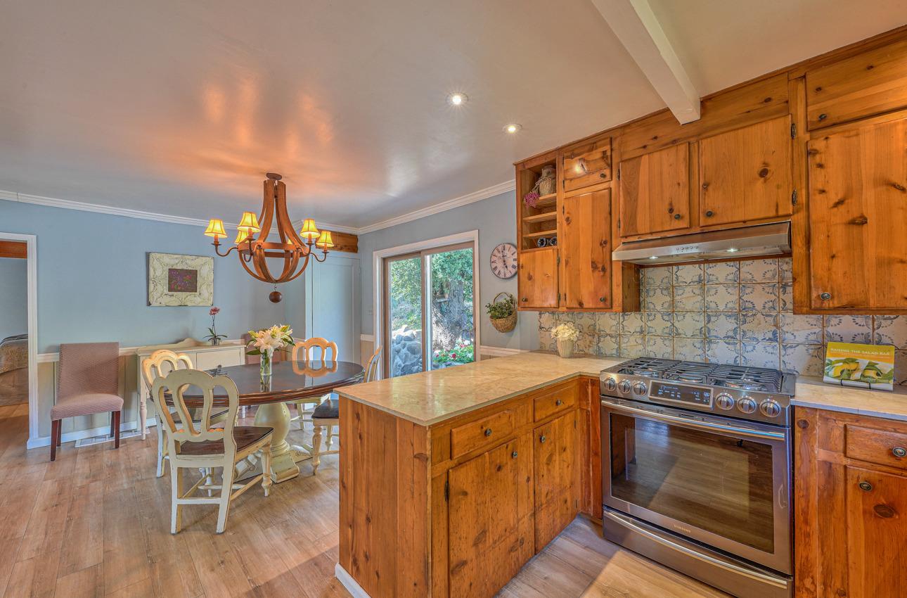 7 Paso Cresta Carmel Valley, CA 93924 - Photo 16 of 44 a kitchen that has a table chairs and a stove