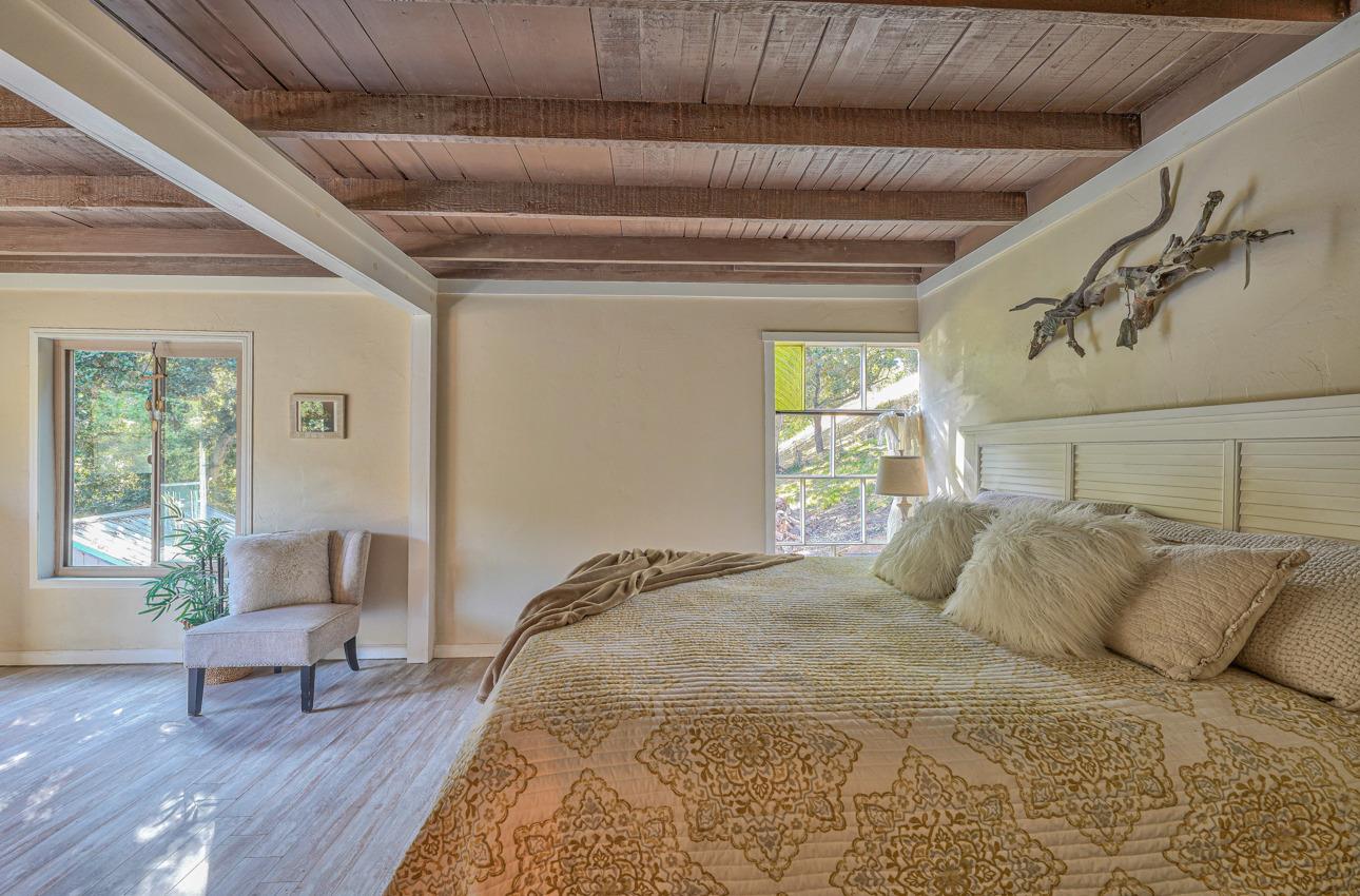 7 Paso Cresta Carmel Valley, CA 93924 - Photo 18 of 44 a bedroom with a bed and wooden floor
