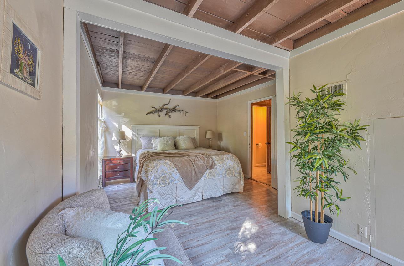 7 Paso Cresta Carmel Valley, CA 93924 - Photo 19 of 44 a bedroom with a bed and a potted plant