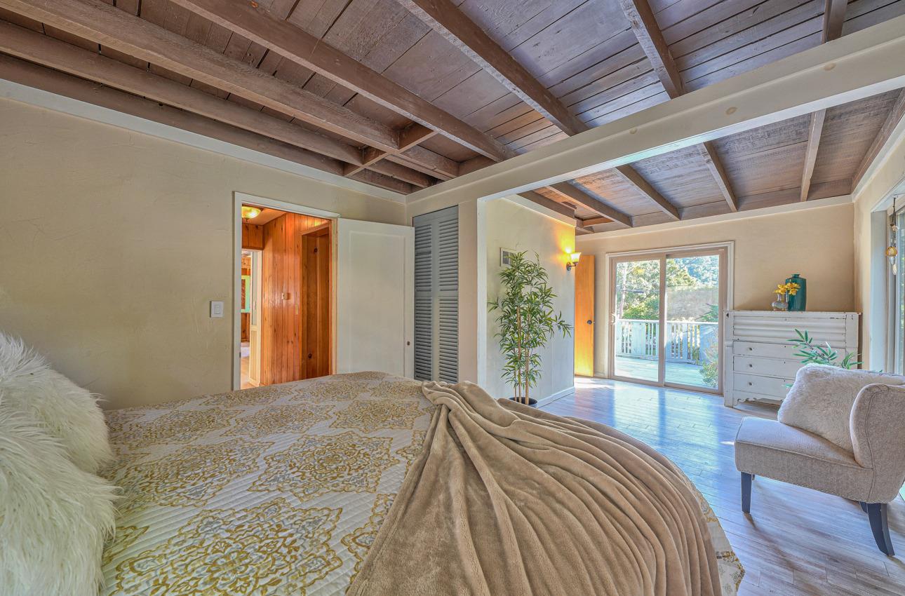 7 Paso Cresta Carmel Valley, CA 93924 - Photo 20 of 44 a bedroom with a large bed and a large window
