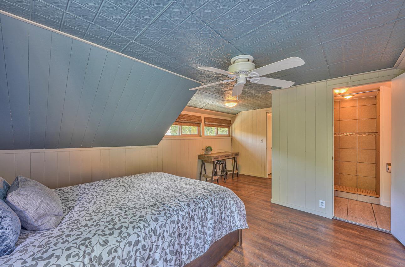 7 Paso Cresta Carmel Valley, CA 93924 - Photo 28 of 44 a bedroom with a bed and a chandelier