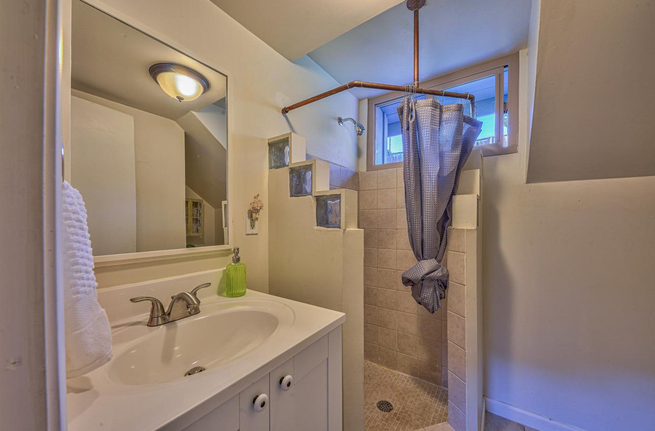 7 Paso Cresta Carmel Valley, CA 93924 - Photo 34 of 44 a bathroom with a sink a mirror and shower