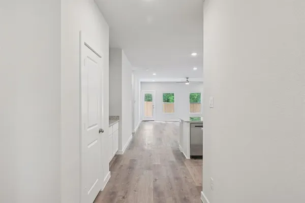 a view of a hallway with wooden floor