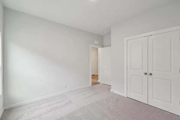 a view of an empty room and closet area