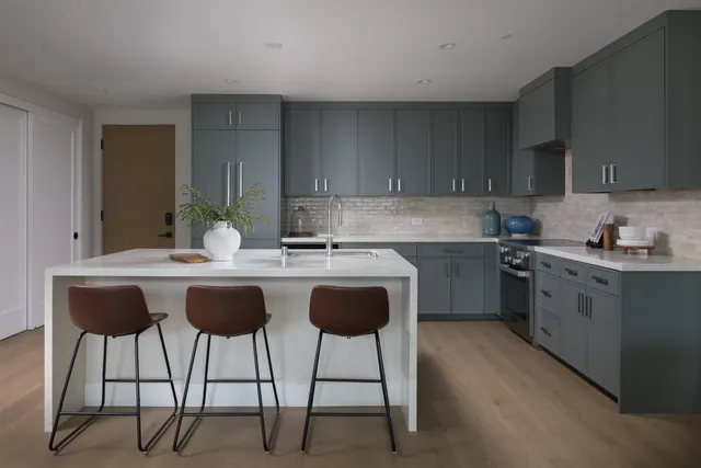 a kitchen with a sink cabinets and window