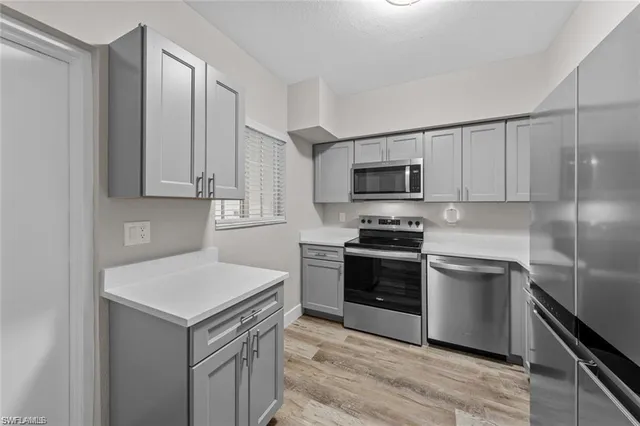 a kitchen with a sink stove and refrigerator