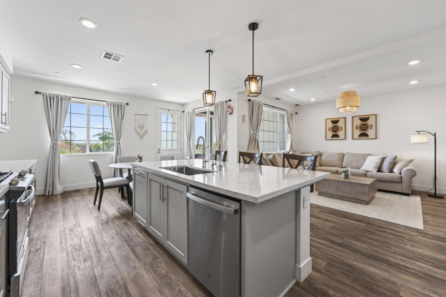 9532 Seawind Way Newark, CA 94560 - Photo 10 of 44 a living room with stainless steel appliances kitchen island a table chairs refrigerator and sink
