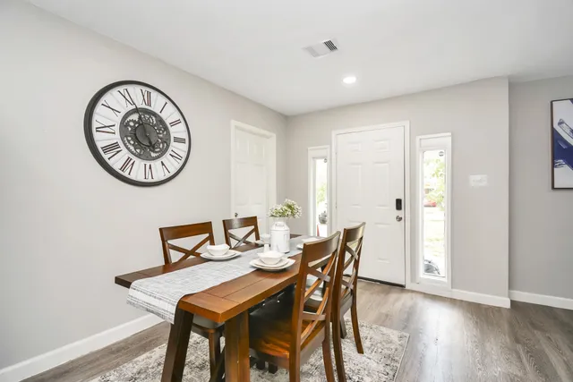 a view of a dining room with furniture and wooden floor