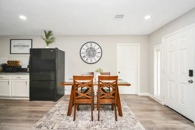 a view of a dining area with furniture and wooden floor