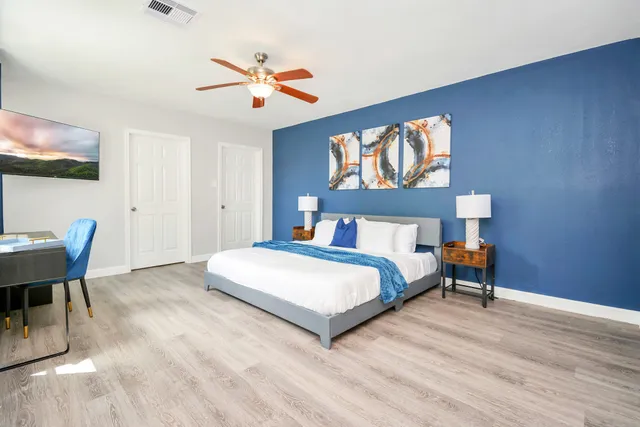 a bedroom with a bed and table