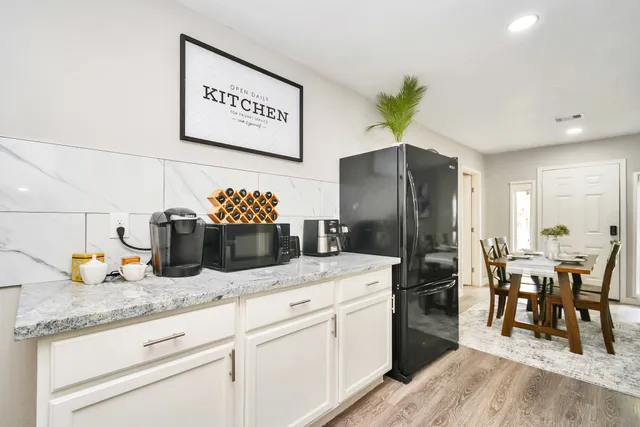 a kitchen with sink and refrigerator