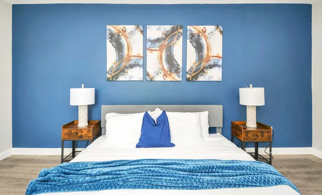 a bedroom with a bed and a lamp on table