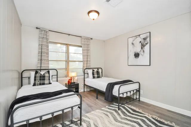 a bedroom with furniture and a window