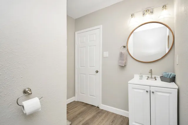 a bathroom with a sink mirror and vanity