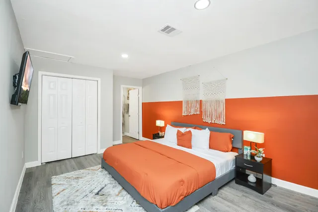 a bed room with a bed and a night stand