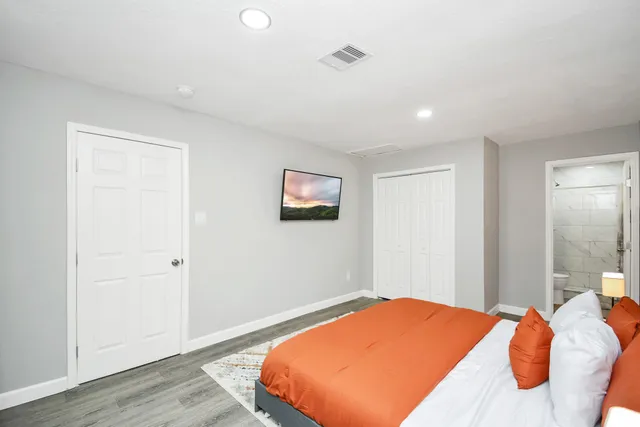 a bed room with a bed and a painting