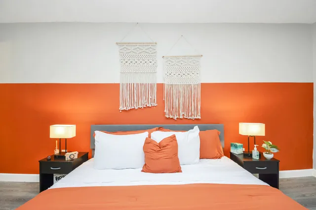 a bedroom with a bed and lamps