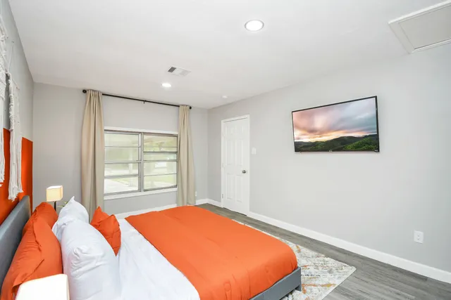 a bedroom with a bed and a window