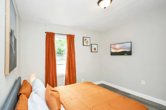 a bedroom with a bed and a window