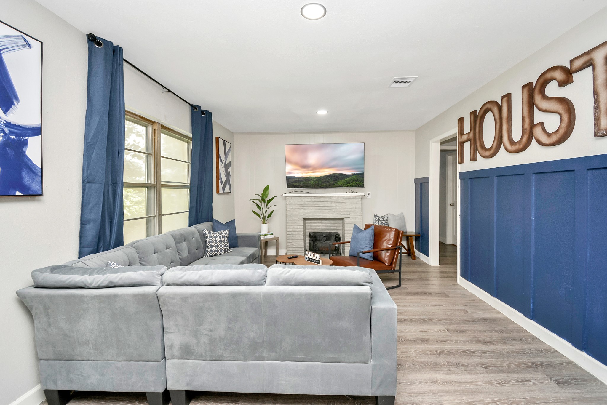 4710 Paradise Lane Houston, TX 77048 - Photo 7 of 42 a living room with furniture a fireplace and a flat screen tv