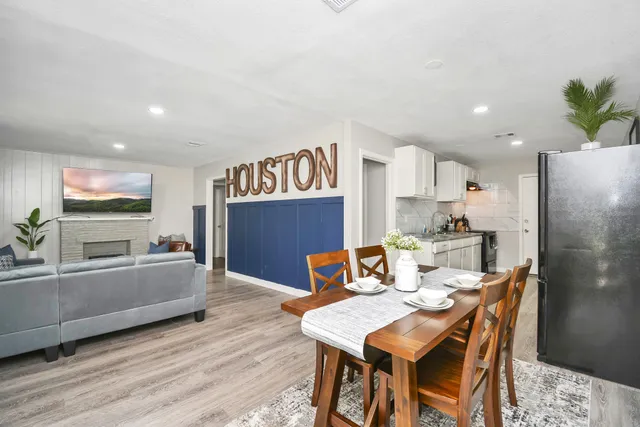 a dining room with furniture and a kitchen view