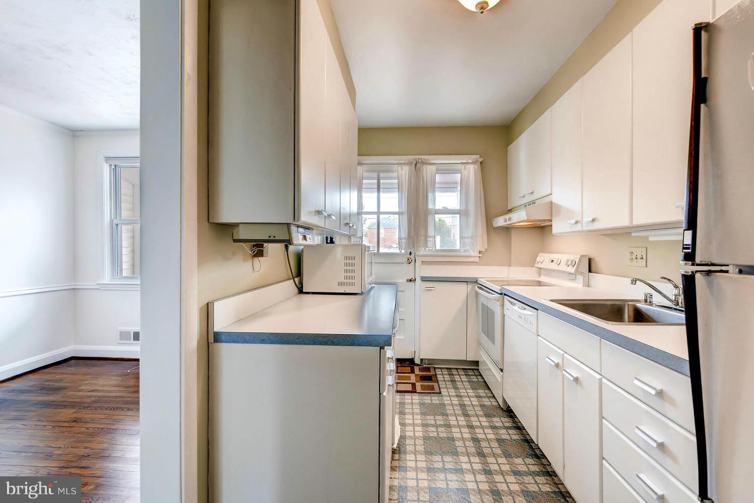 8325 Byington Road Baltimore, MD 21286 - Photo 13 of 28 a kitchen with sink cabinets and window