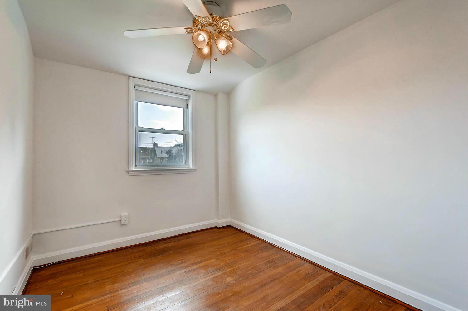 8325 Byington Road Baltimore, MD 21286 - Photo 15 of 28 an empty room with a window and wooden floor