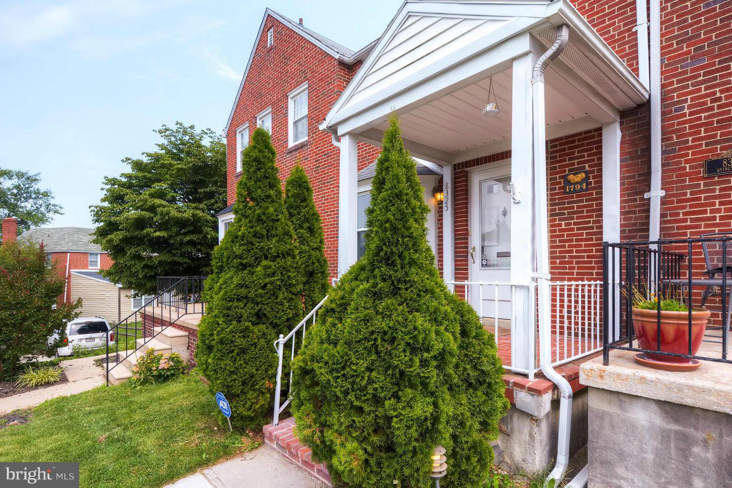 8325 Byington Road Baltimore, MD 21286 - Photo 4 of 28 front view of house with a yard and potted plants