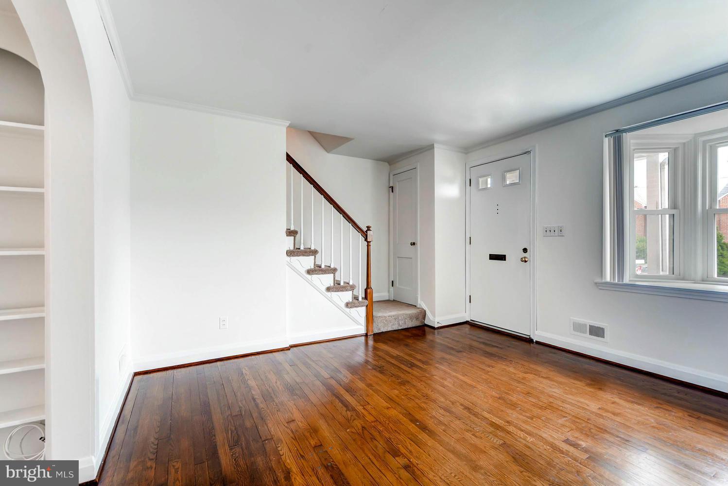 8325 Byington Road Baltimore, MD 21286 - Photo 7 of 28 wooden floor in an empty room with a window