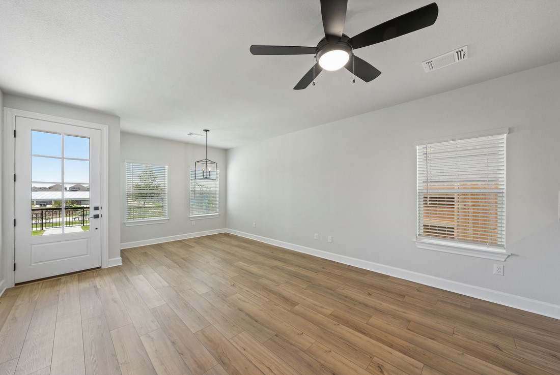 9316 Gladsome Path Manor, TX 78653 - Photo 2 of 18 a view of an empty room with a window and wooden floor