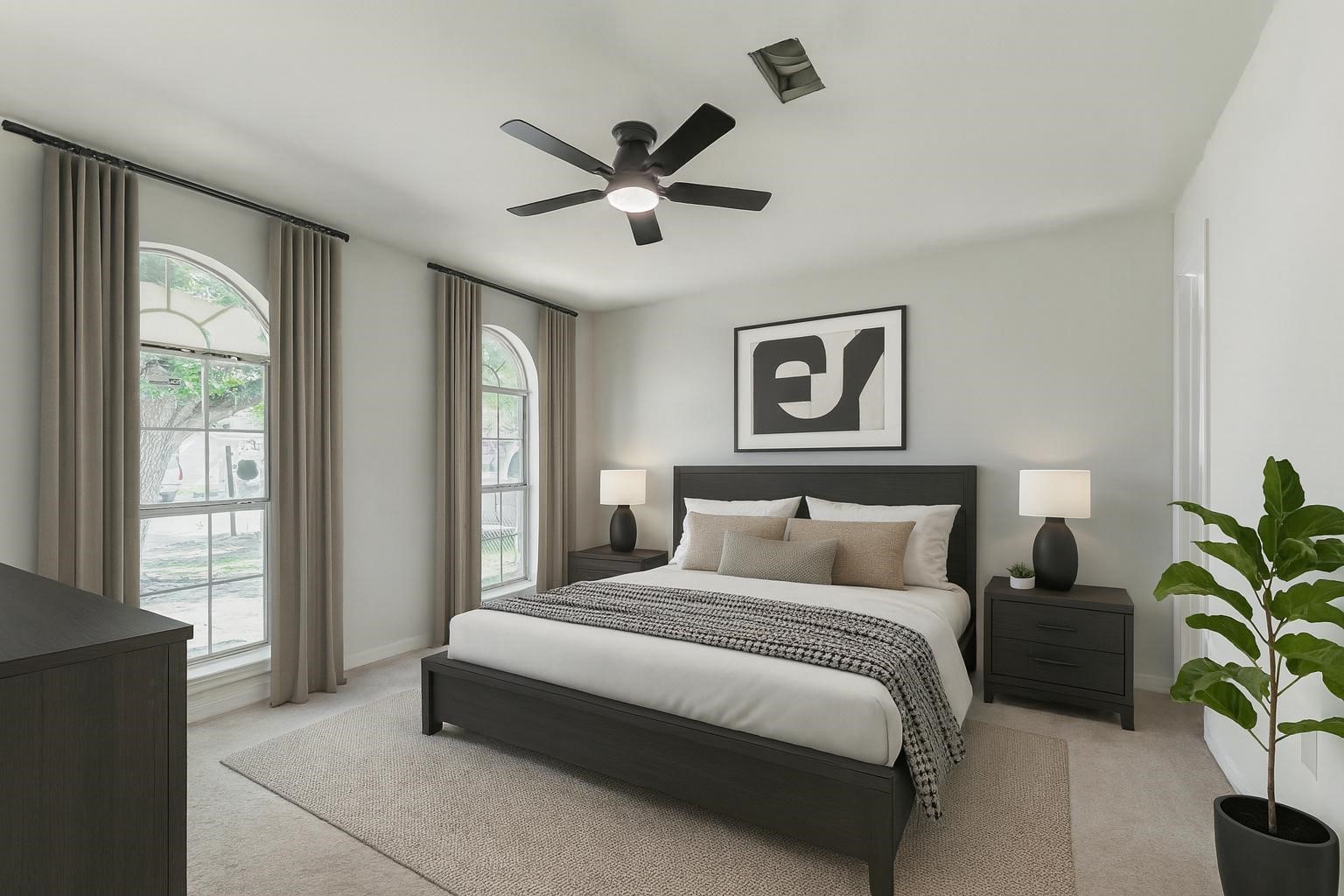 10102 Wiggins Street Houston, TX 77029 - Photo 11 of 26 a bedroom with a large bed and a potted plant