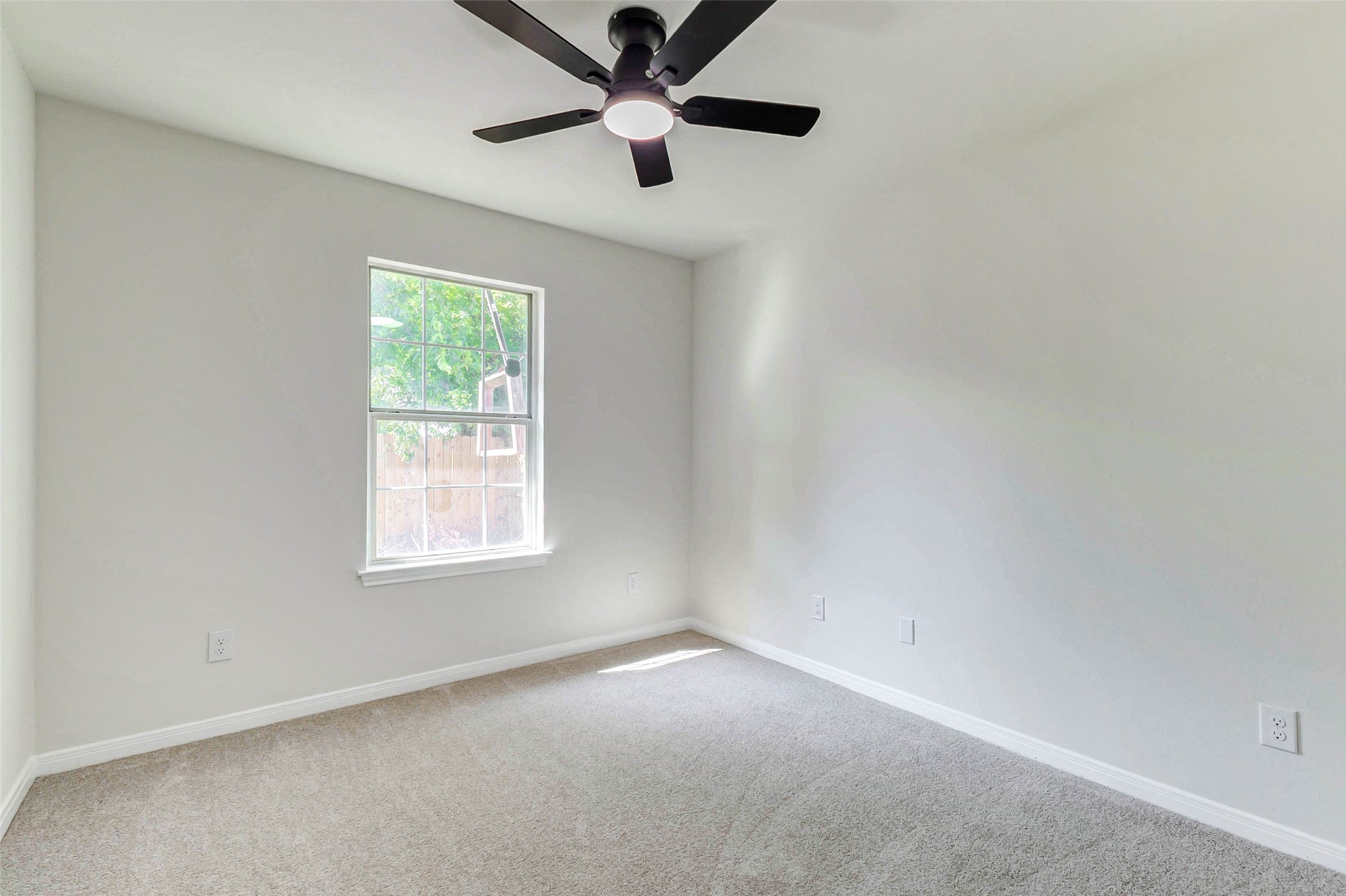 10102 Wiggins Street Houston, TX 77029 - Photo 16 of 26 an empty room with a window and a fan