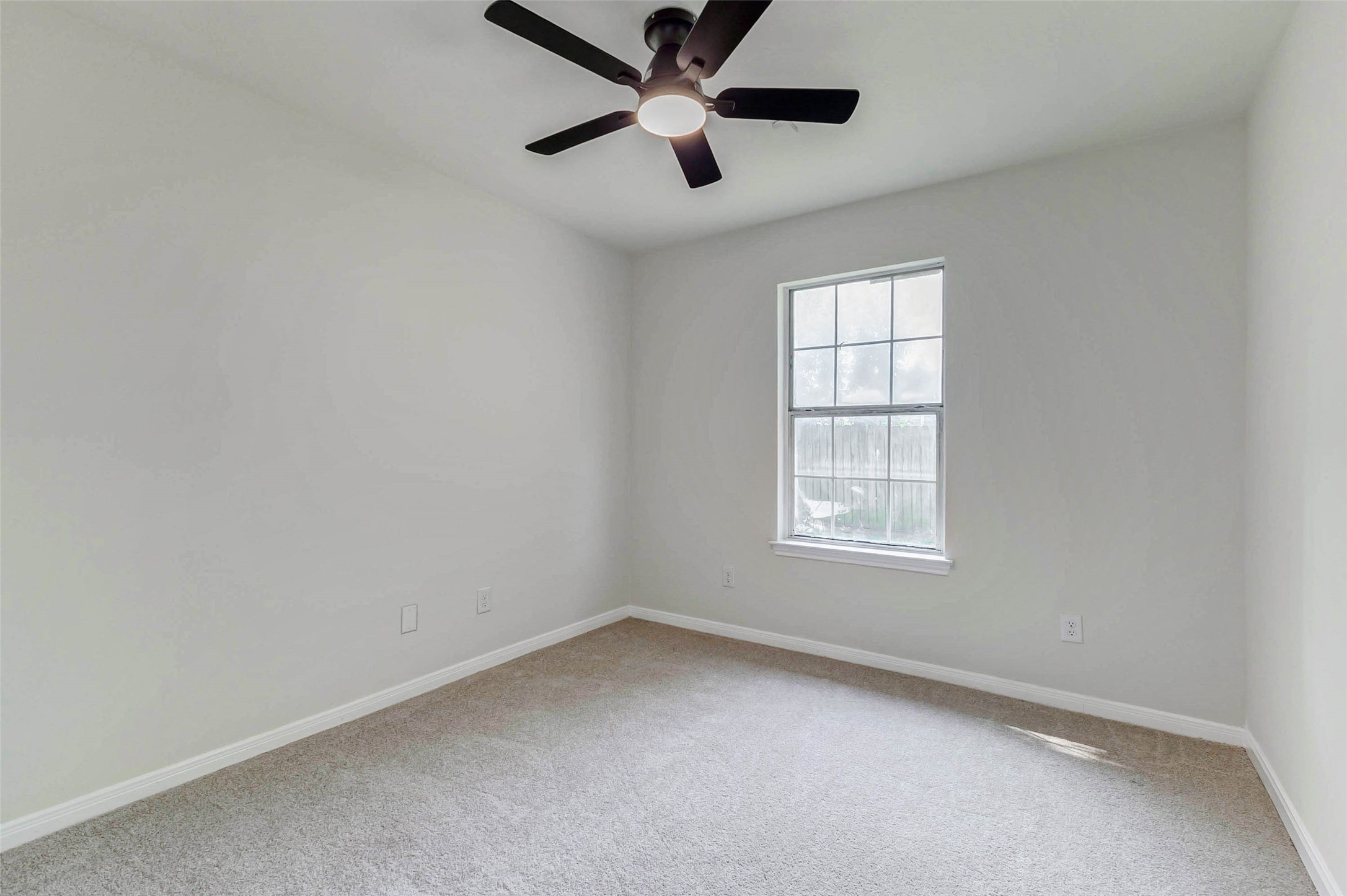 10102 Wiggins Street Houston, TX 77029 - Photo 20 of 26 an empty room with a window and a fan