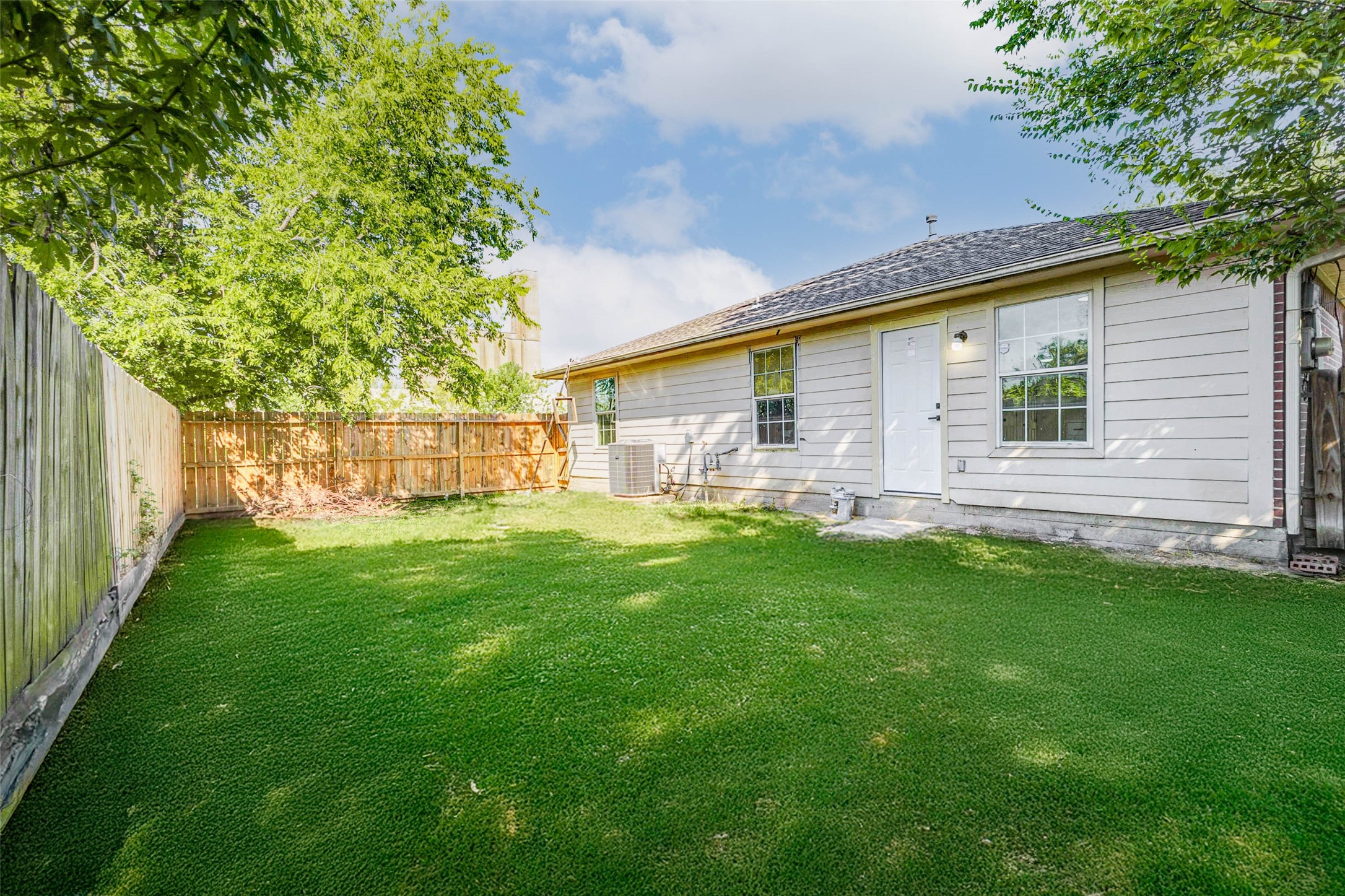 10102 Wiggins Street Houston, TX 77029 - Photo 25 of 26 a front view of a house with a garden