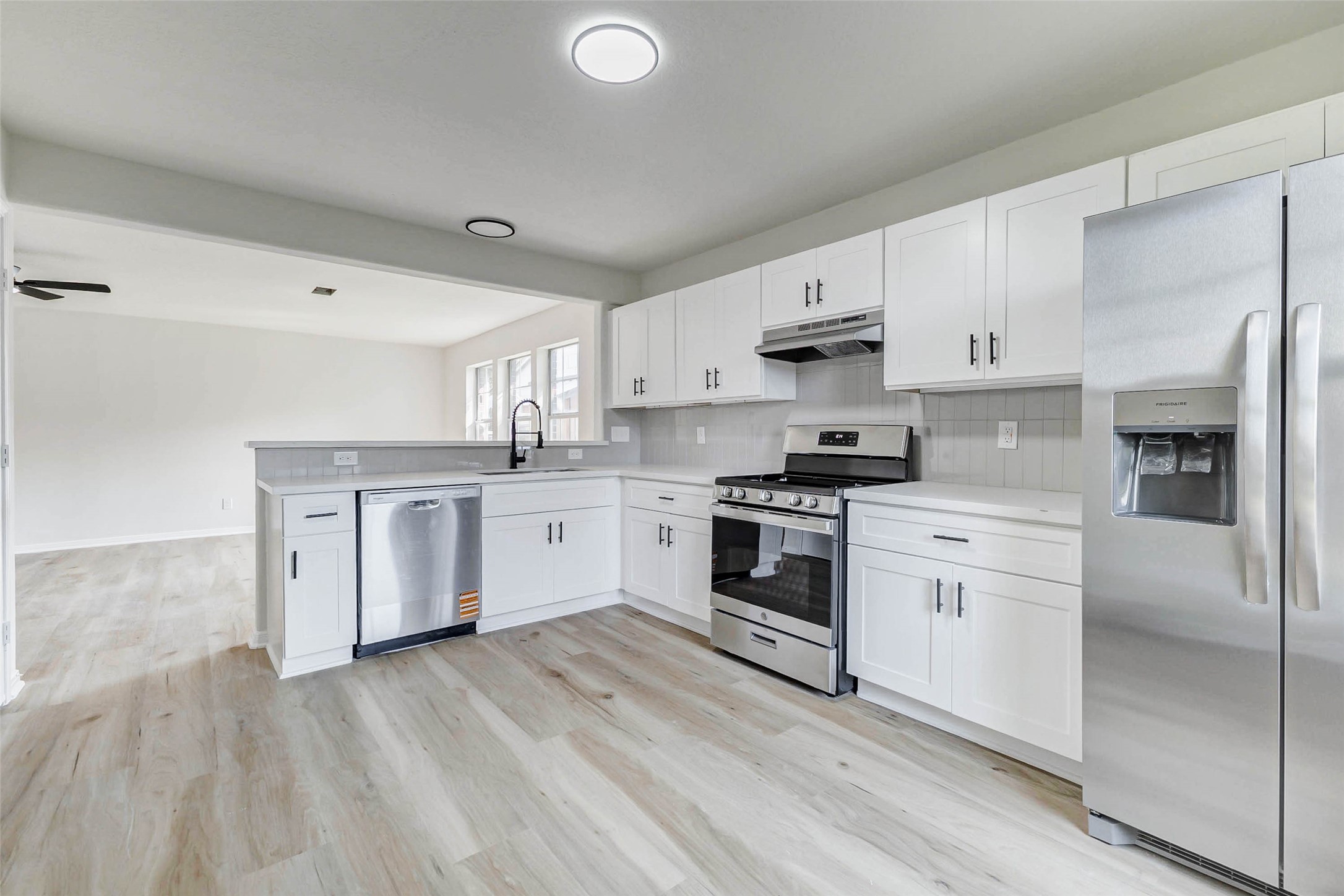 10102 Wiggins Street Houston, TX 77029 - Photo 4 of 26 a kitchen with granite countertop white cabinets and white appliances